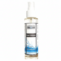 A bottle of Lather & More Cool Stream Dry Body Oil with a white spray cap and a white label featuring blue water graphics, set against a plain white background.