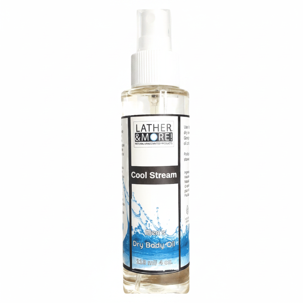 A bottle of Lather & More Cool Stream Dry Body Oil with a white spray cap and a white label featuring blue water graphics, set against a plain white background.