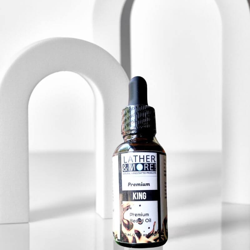 A bottle of KING Premium Beard Oil by LATHER & MORE, placed against a white background with a shadow cast upon it.