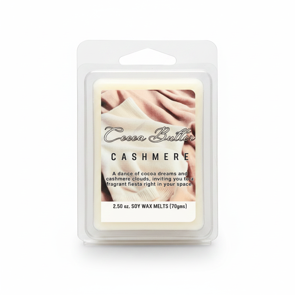 A packaged soy wax melt in a clear plastic clamshell package. The label reads 'Cocoa Butter CASHMERE' with a warm cream and blush-toned photo of folded fabric and an open book.